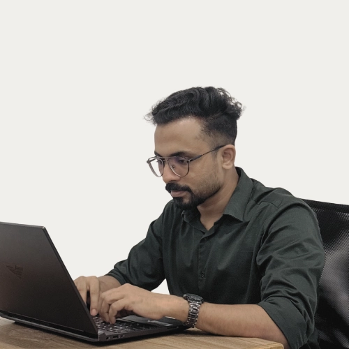 Irshad, freelance web developer in Malappuram working on a laptop